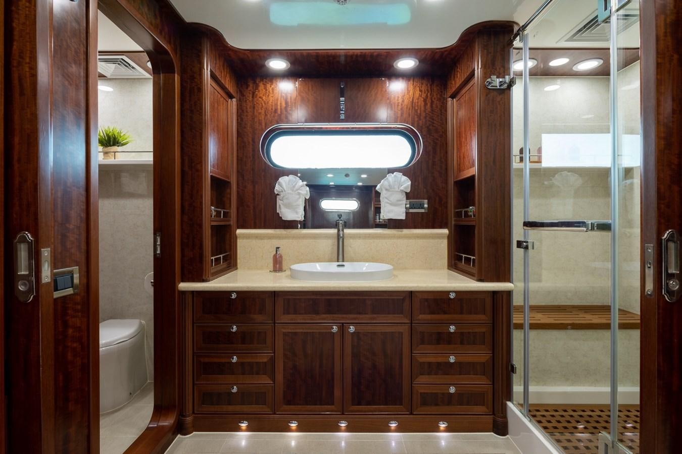a bathroom with a glass shower aboard BEYOND CAPRICORN Yacht for Sale