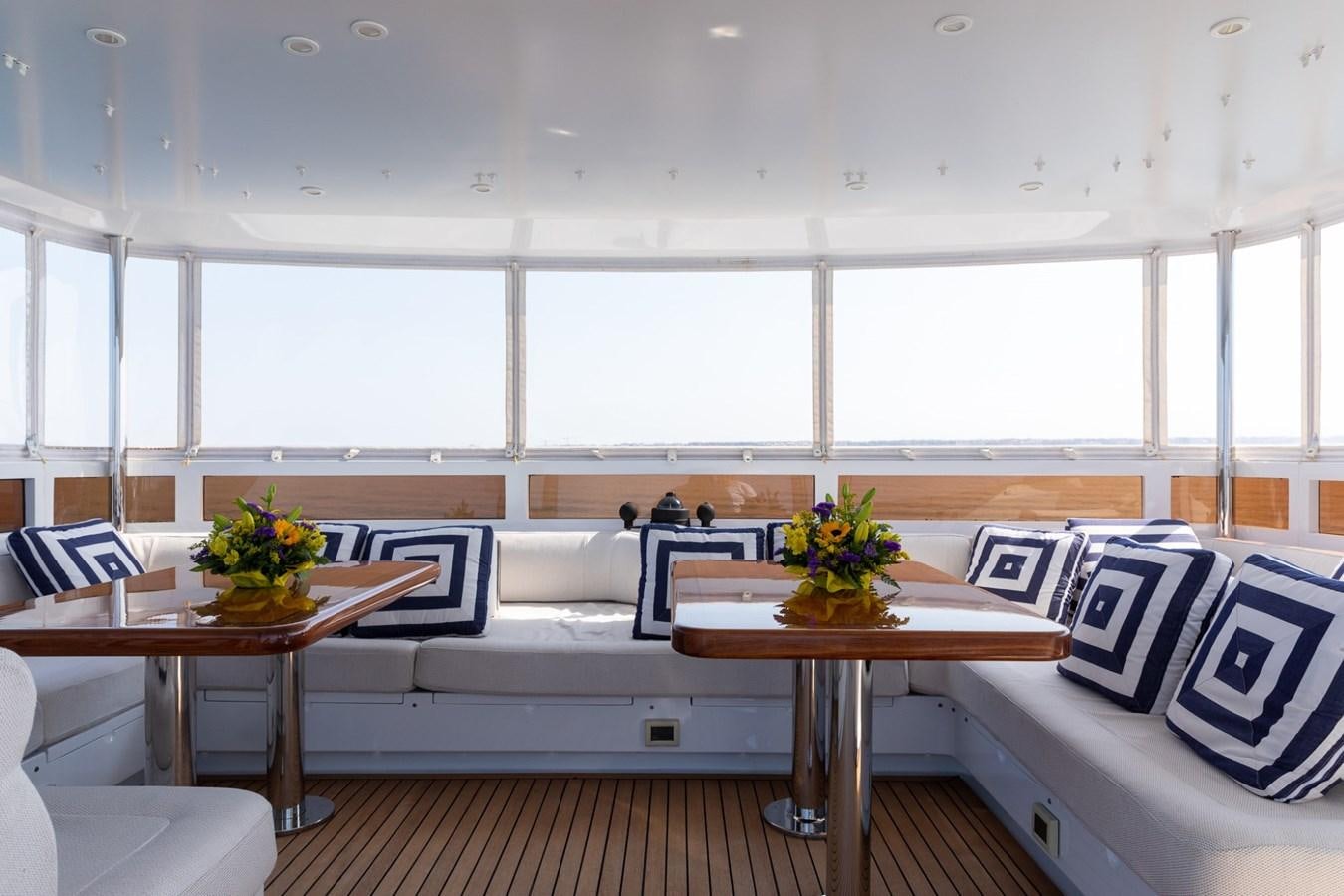 a room with a couch and a table aboard BEYOND CAPRICORN Yacht for Sale