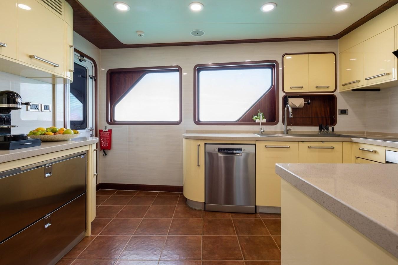 a kitchen with a tile floor aboard BEYOND CAPRICORN Yacht for Sale