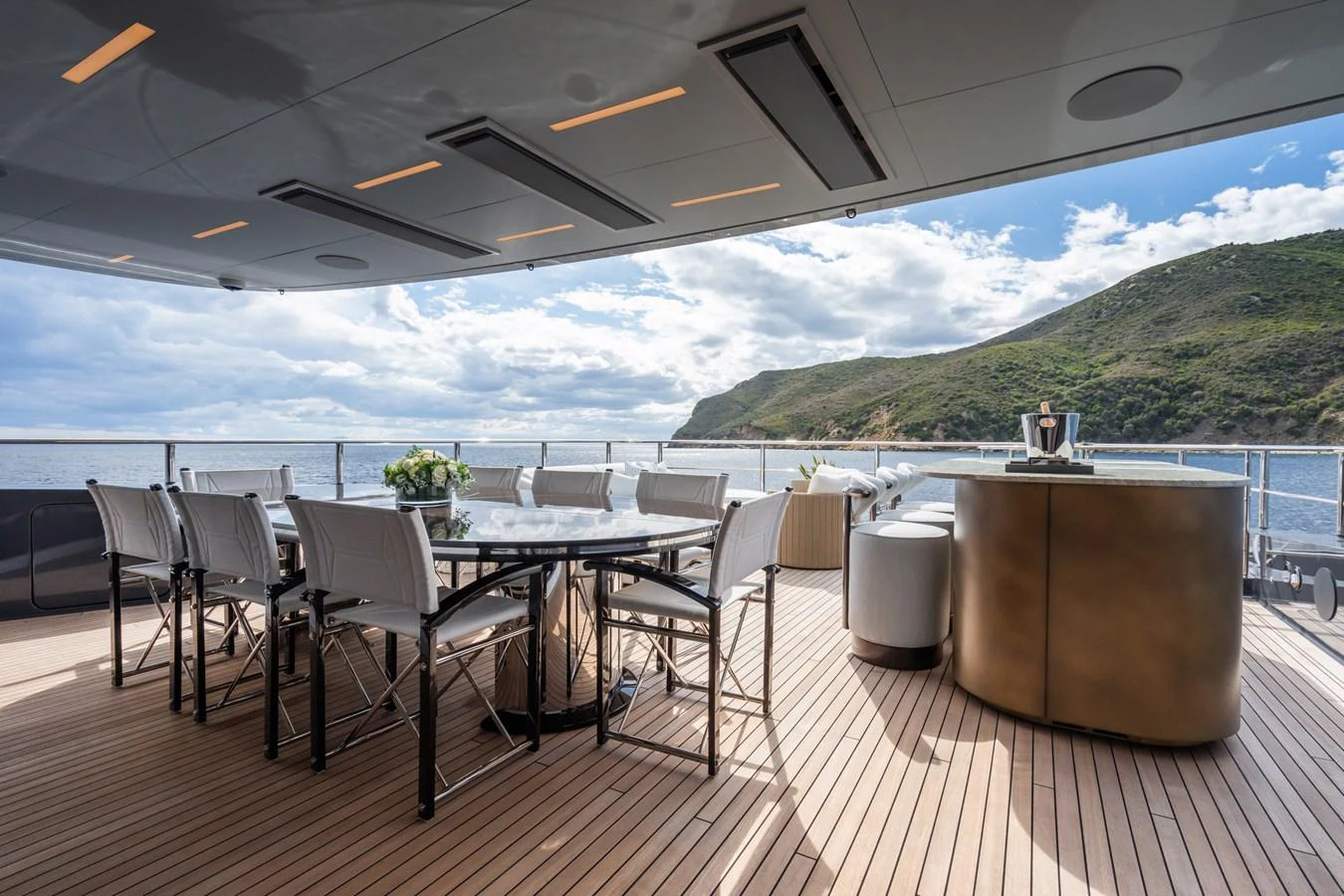 a table and chairs on a deck aboard M Yacht for Sale