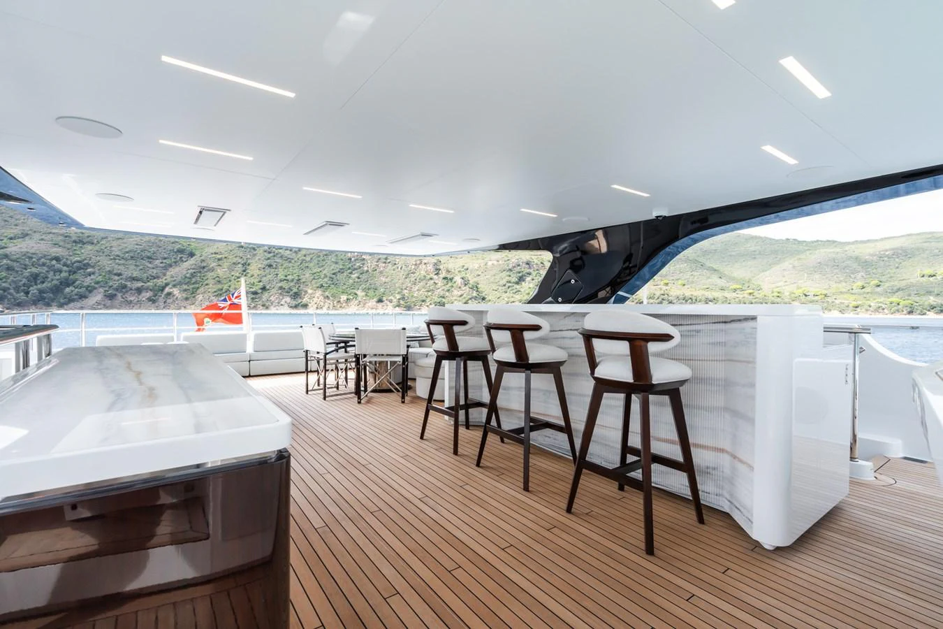 a deck with tables and chairs aboard M Yacht for Sale