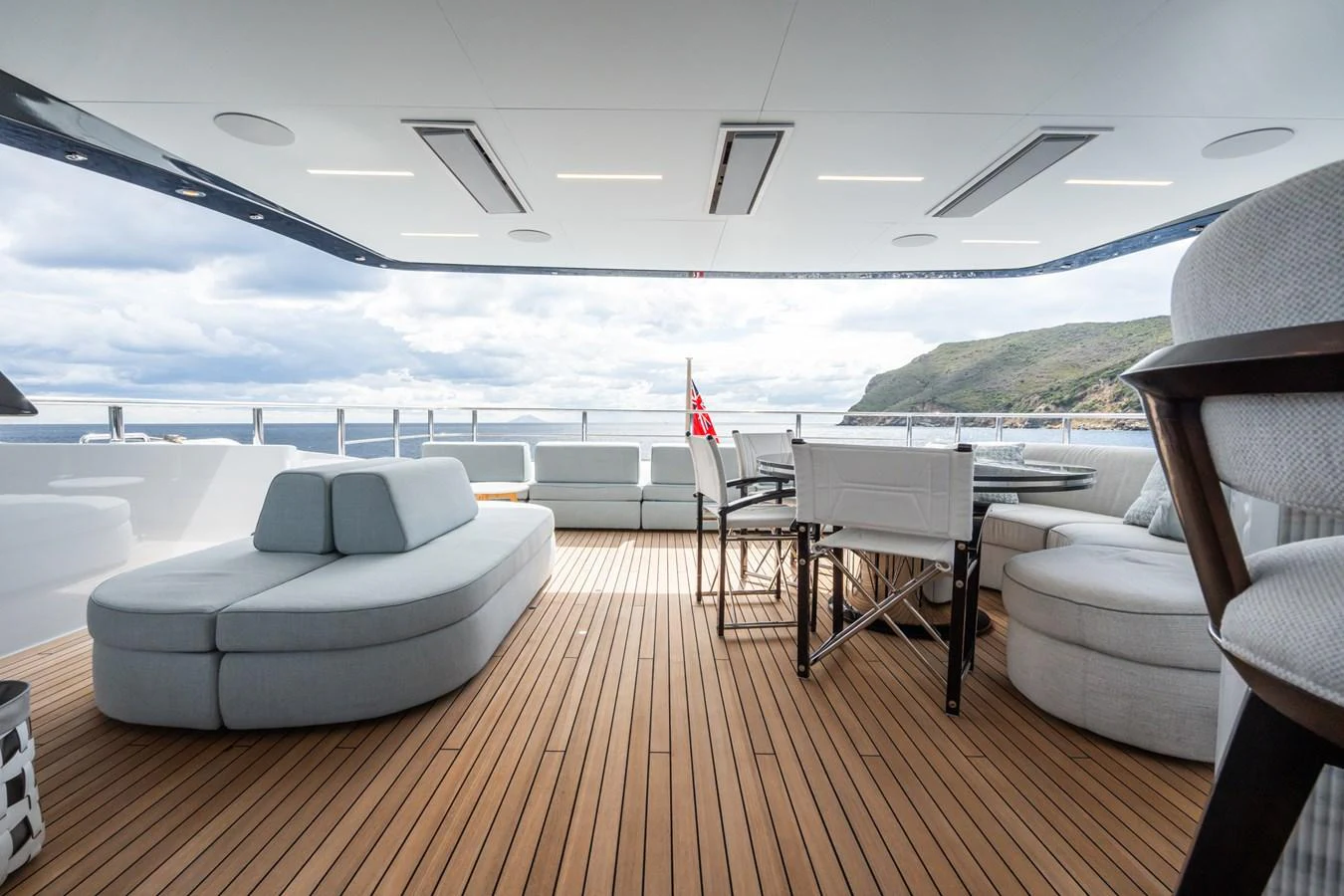 a deck with chairs and tables on it aboard M Yacht for Sale