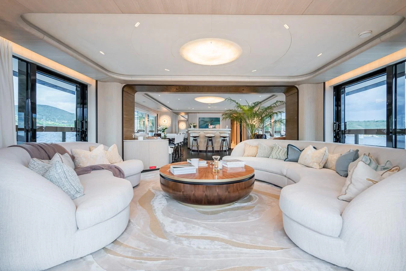 a living room with a table and couches aboard M Yacht for Sale