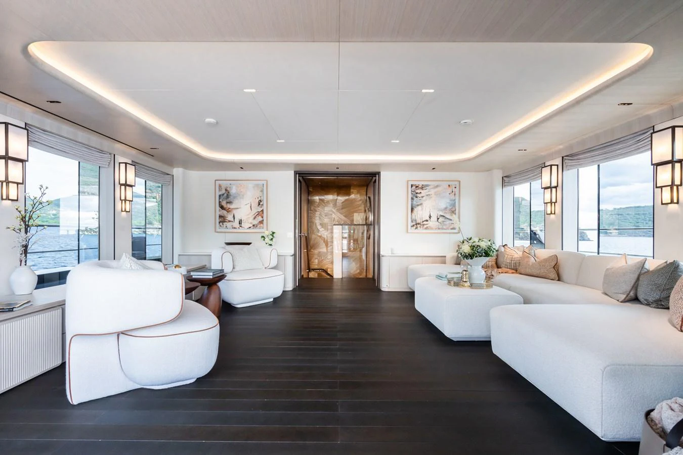 a large living room with white furniture aboard M Yacht for Sale