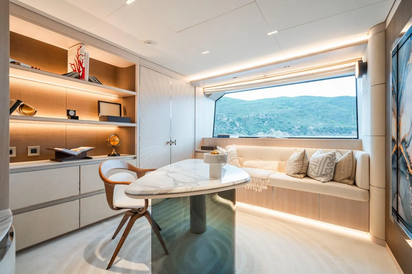 a room with a table and a bed aboard M Yacht for Sale