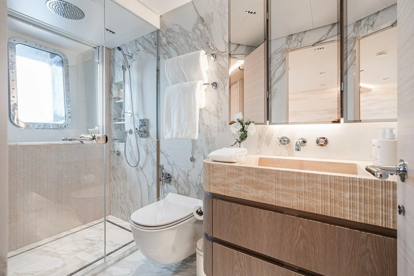 a bathroom with a glass shower aboard M Yacht for Sale