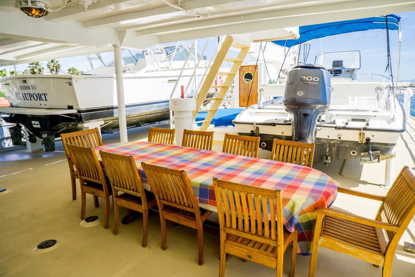 a boat with a table and chairs aboard BEAUPORT Yacht for Sale