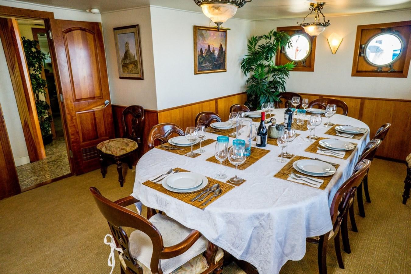 a dining table set for a dinner aboard BEAUPORT Yacht for Sale