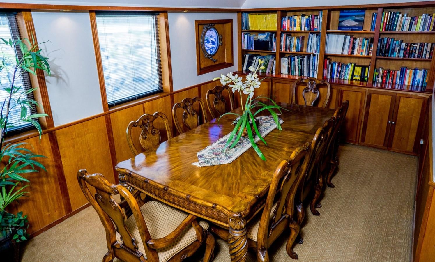 a dining table in a room aboard BEAUPORT Yacht for Sale