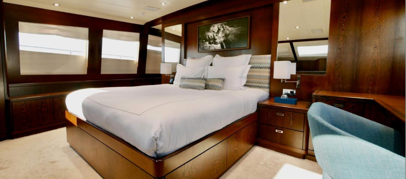 a room with a bed and a dresser aboard ASCENSION Yacht for Sale