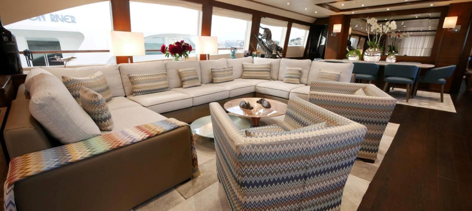 a living room with couches and a table aboard ASCENSION Yacht for Sale