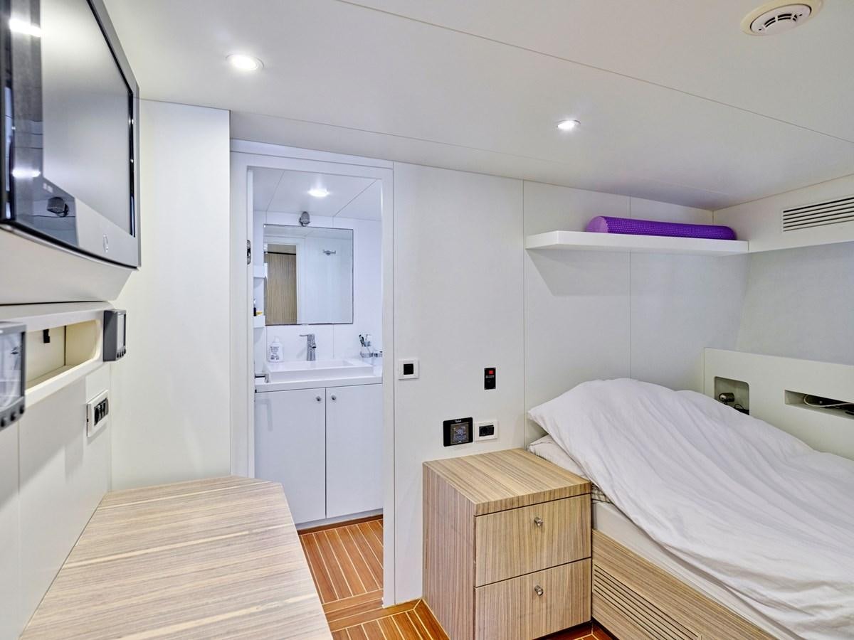 a bedroom with a bed and a table aboard BOOBALE Yacht for Sale