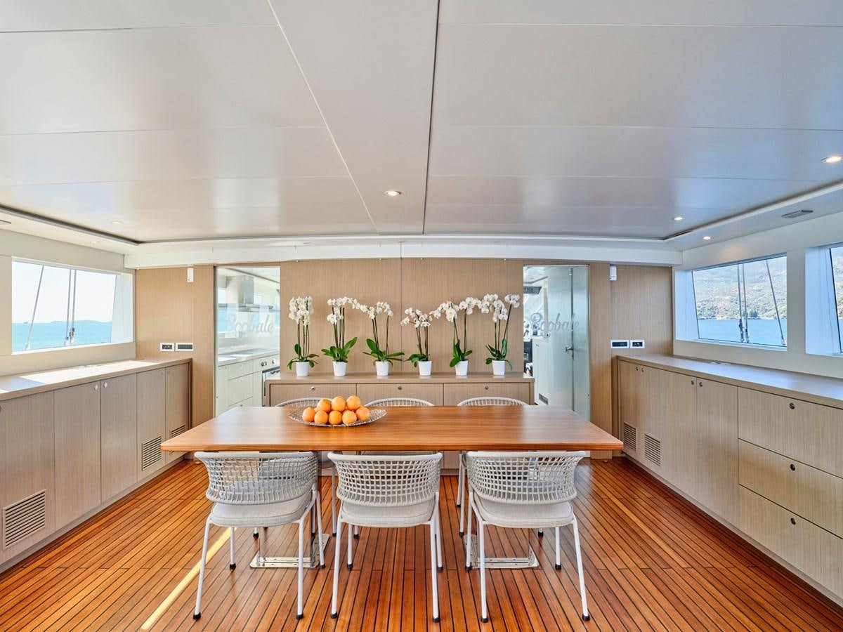 a kitchen with a table and chairs aboard BOOBALE Yacht for Sale