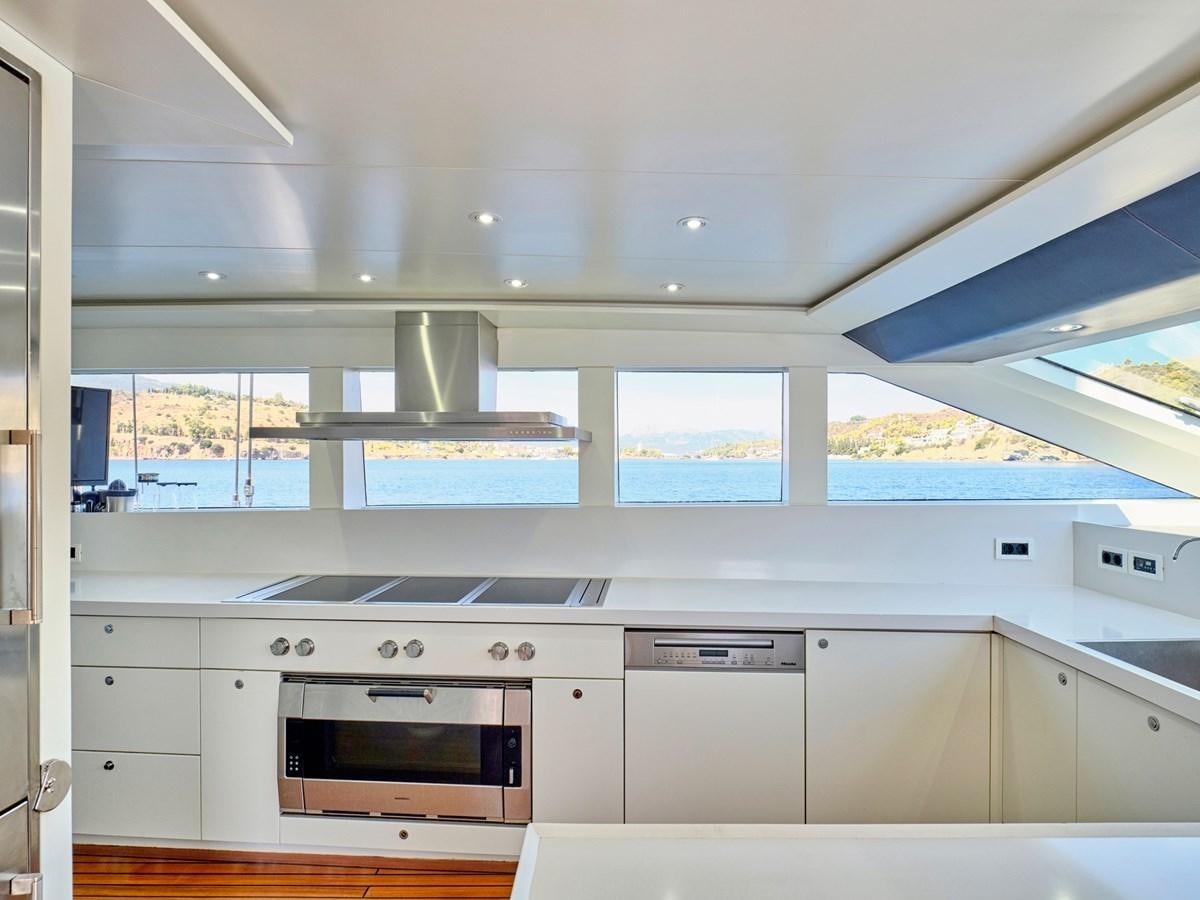 a kitchen with white cabinets aboard BOOBALE Yacht for Sale