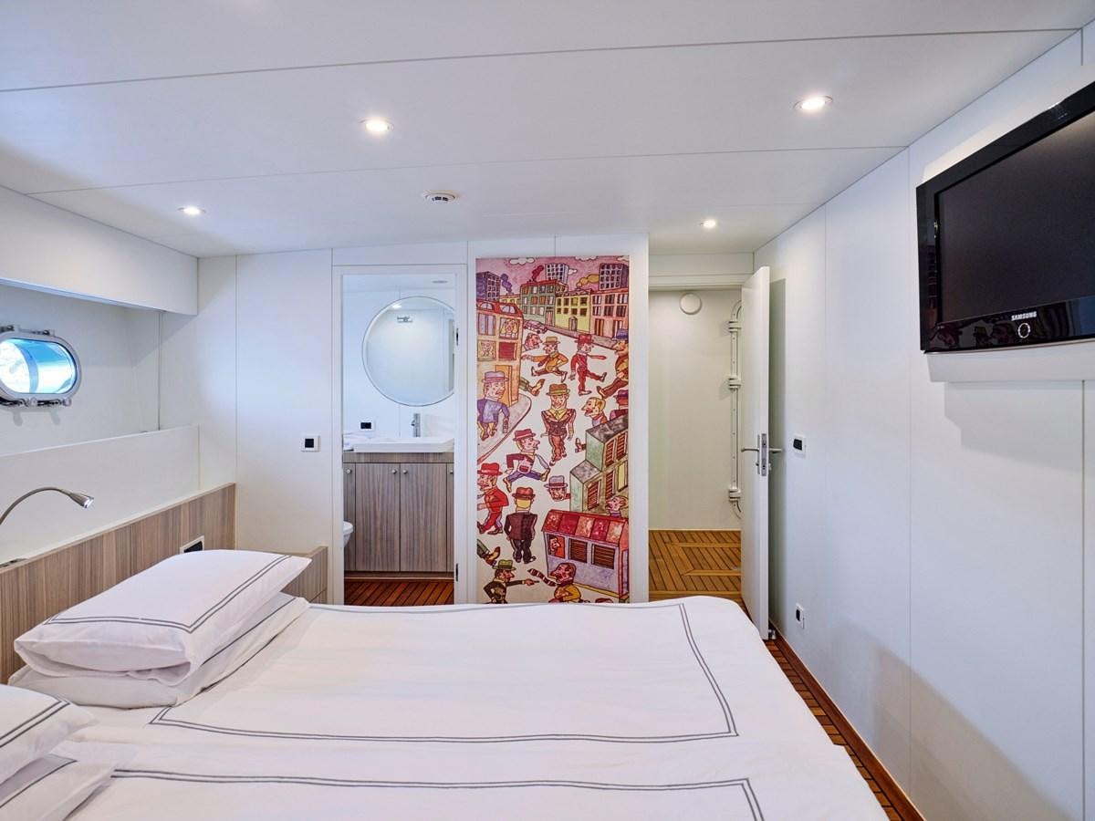 a large bedroom with a large mirror aboard BOOBALE Yacht for Sale