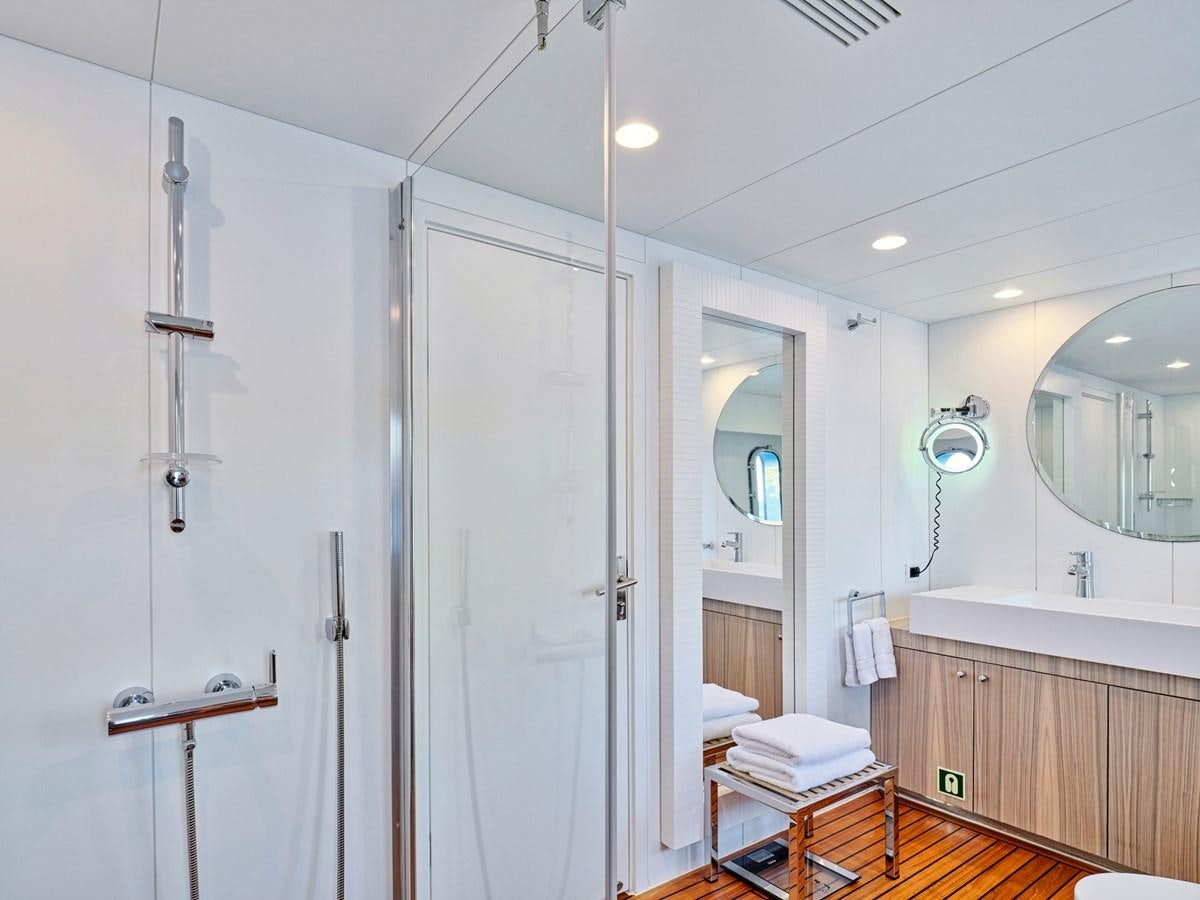 a bathroom with a shower unit and a mirror aboard BOOBALE Yacht for Sale