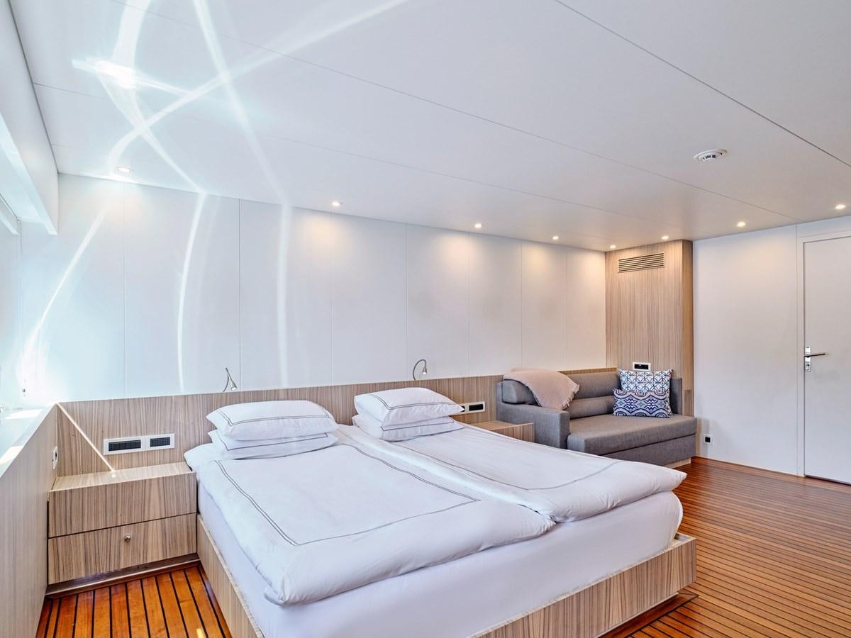 a bedroom with a bed and a couch aboard BOOBALE Yacht for Sale