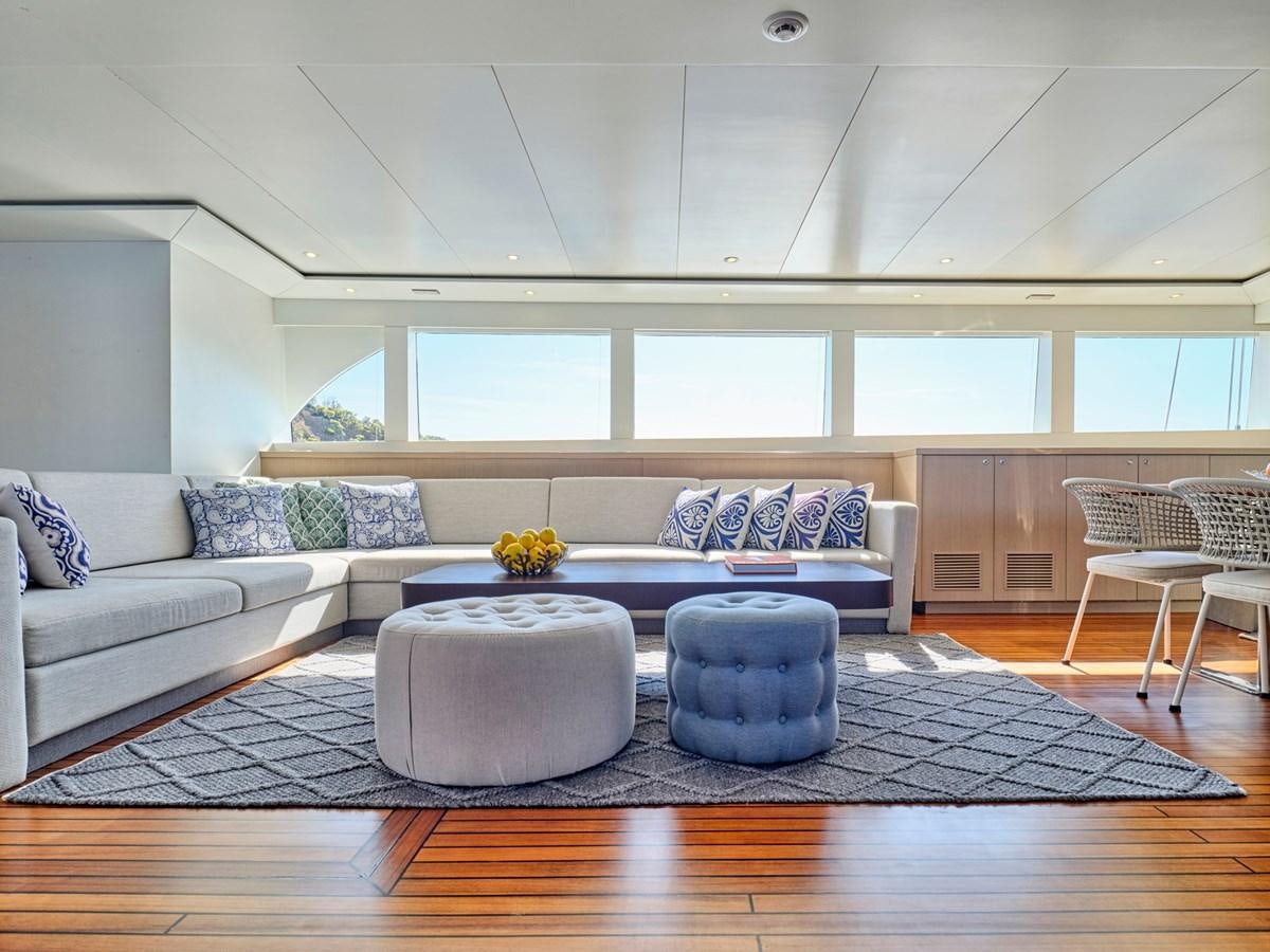 a living room with a couch and a table aboard BOOBALE Yacht for Sale