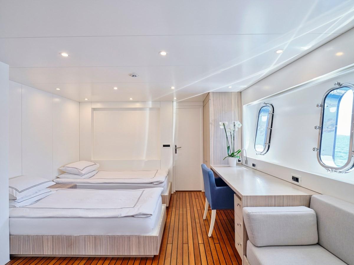 a room with a bed and a chair aboard BOOBALE Yacht for Sale