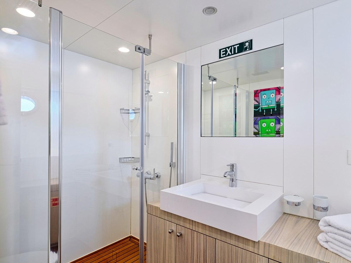 a bathroom with a glass shower aboard BOOBALE Yacht for Sale
