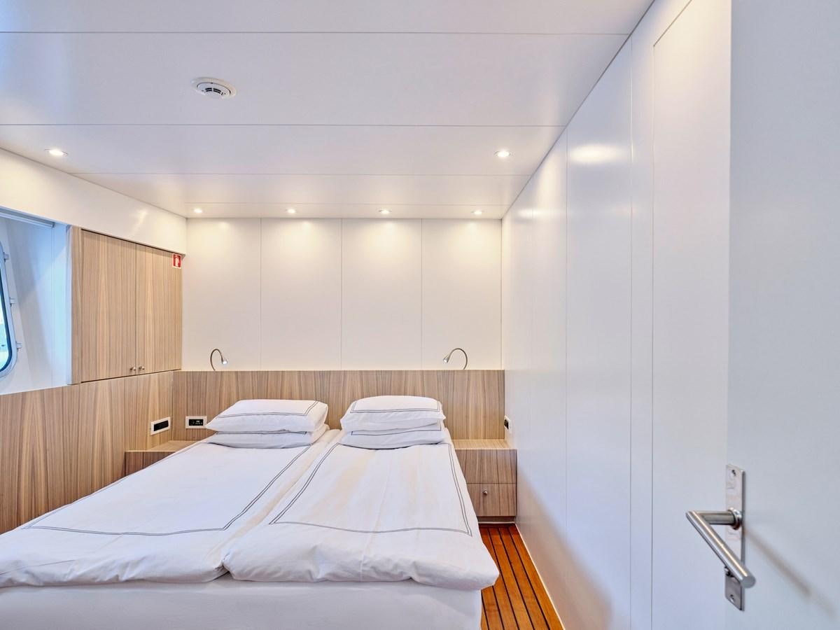 a room with a bed and a mirror aboard BOOBALE Yacht for Sale