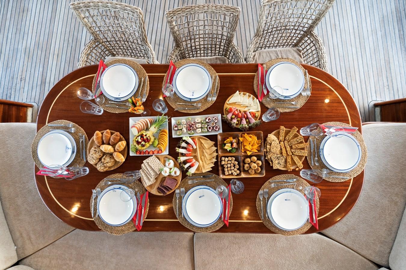 a table with a variety of items on it aboard L'ORIENT Yacht for Sale