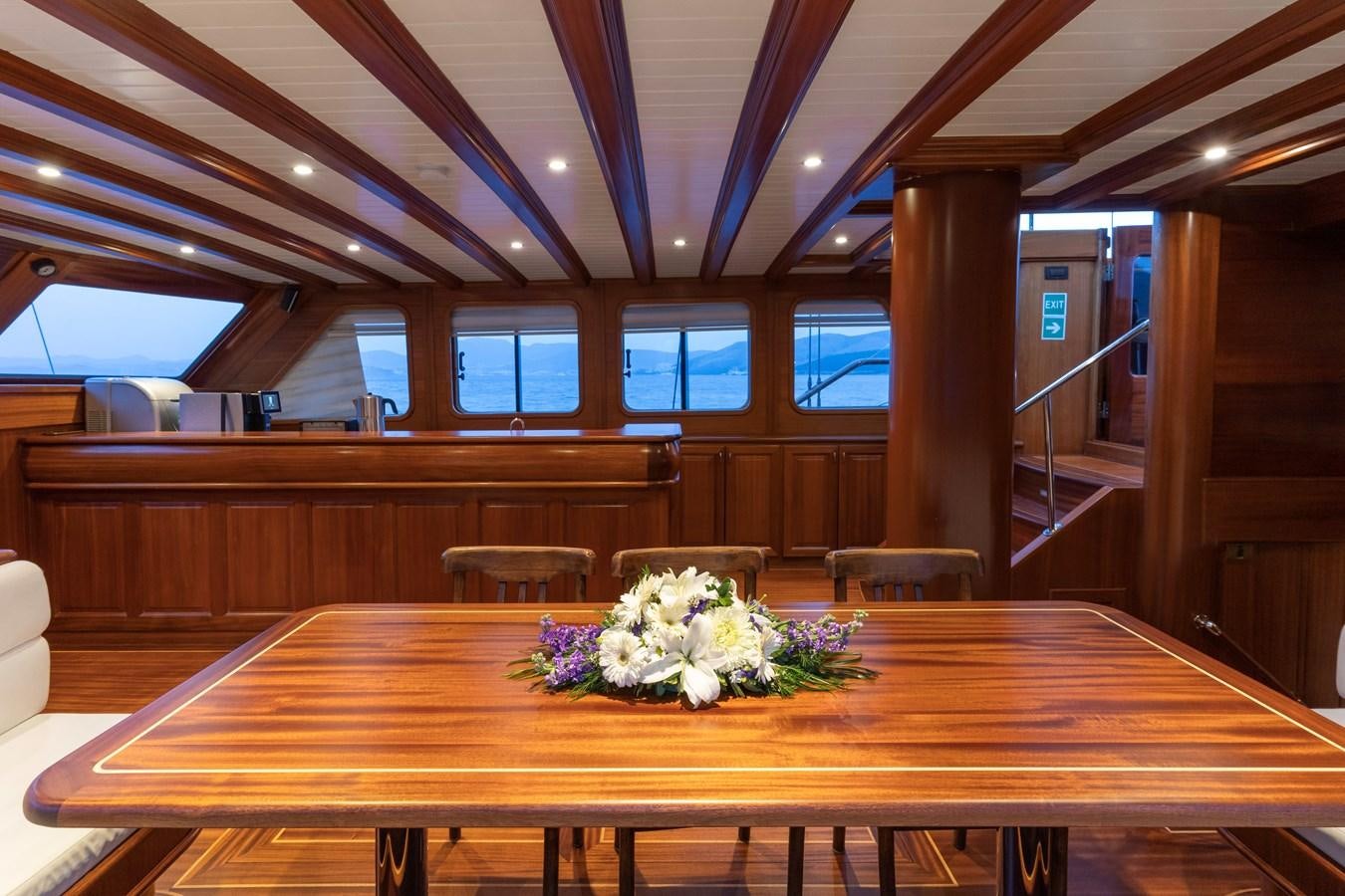 a room with a table and chairs aboard L'ORIENT Yacht for Sale