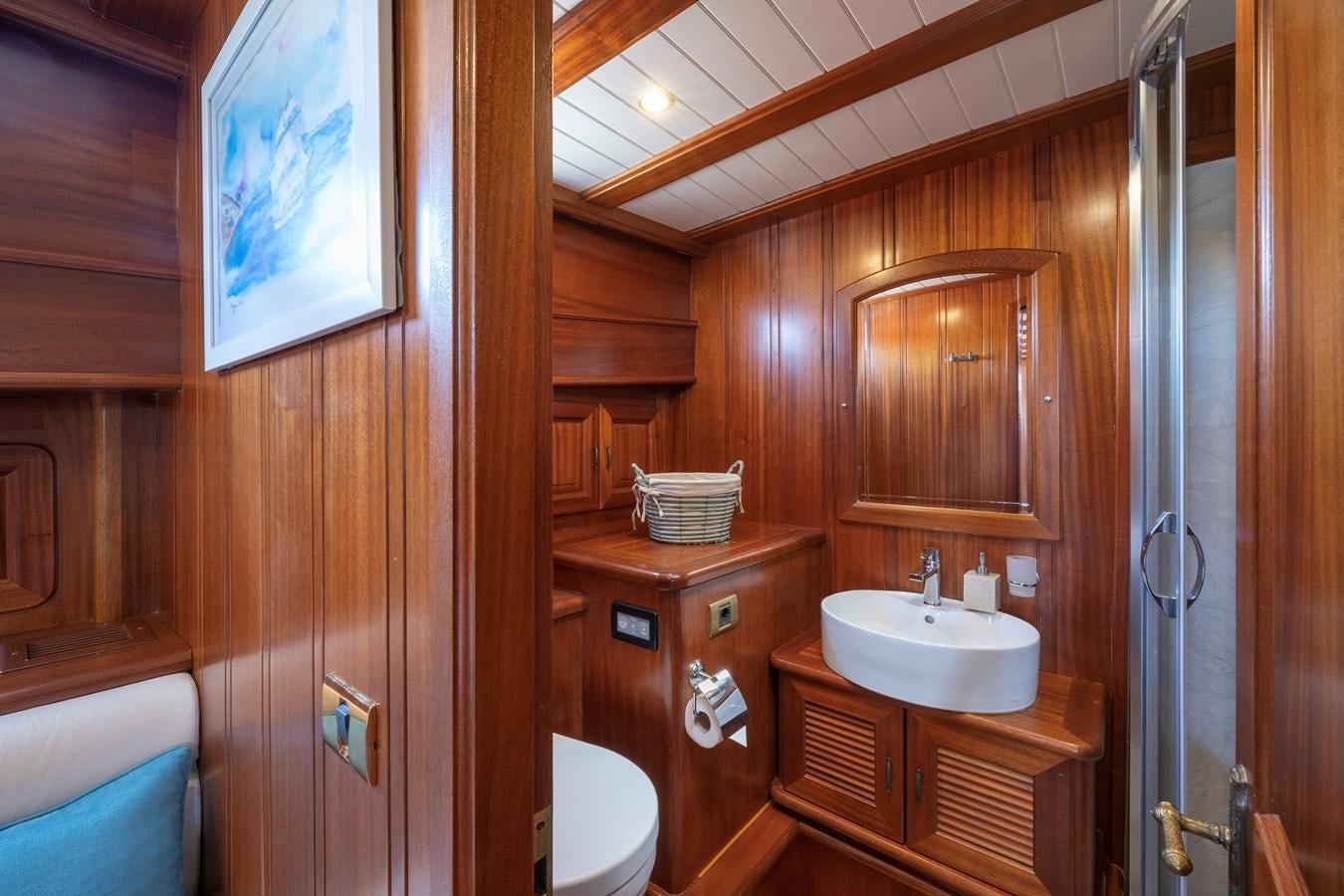 a bathroom with wooden walls aboard L'ORIENT Yacht for Sale