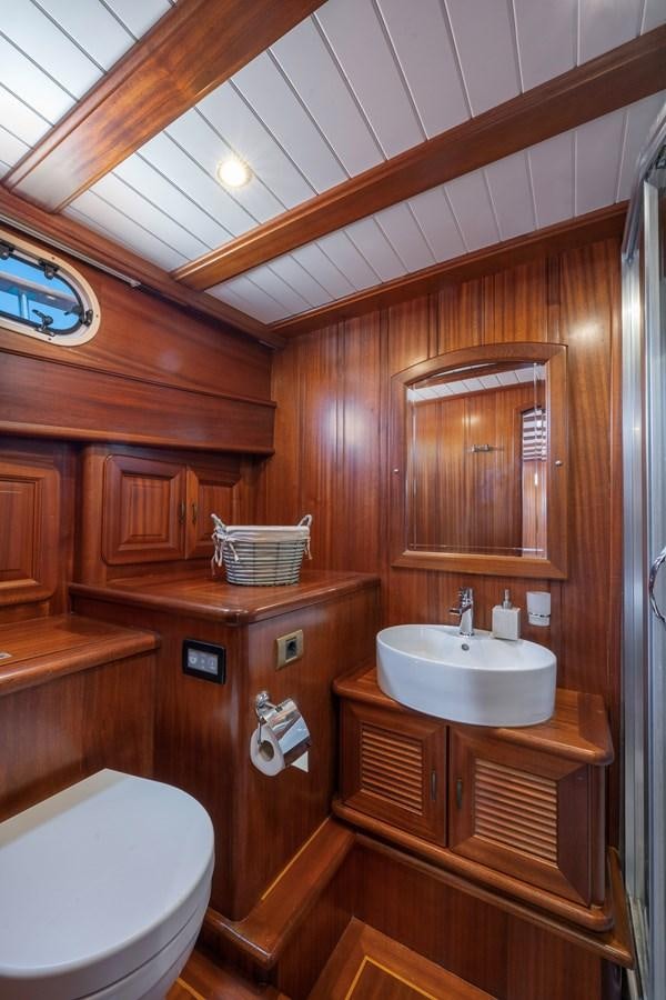 a bathroom with wooden cabinets aboard L'ORIENT Yacht for Sale