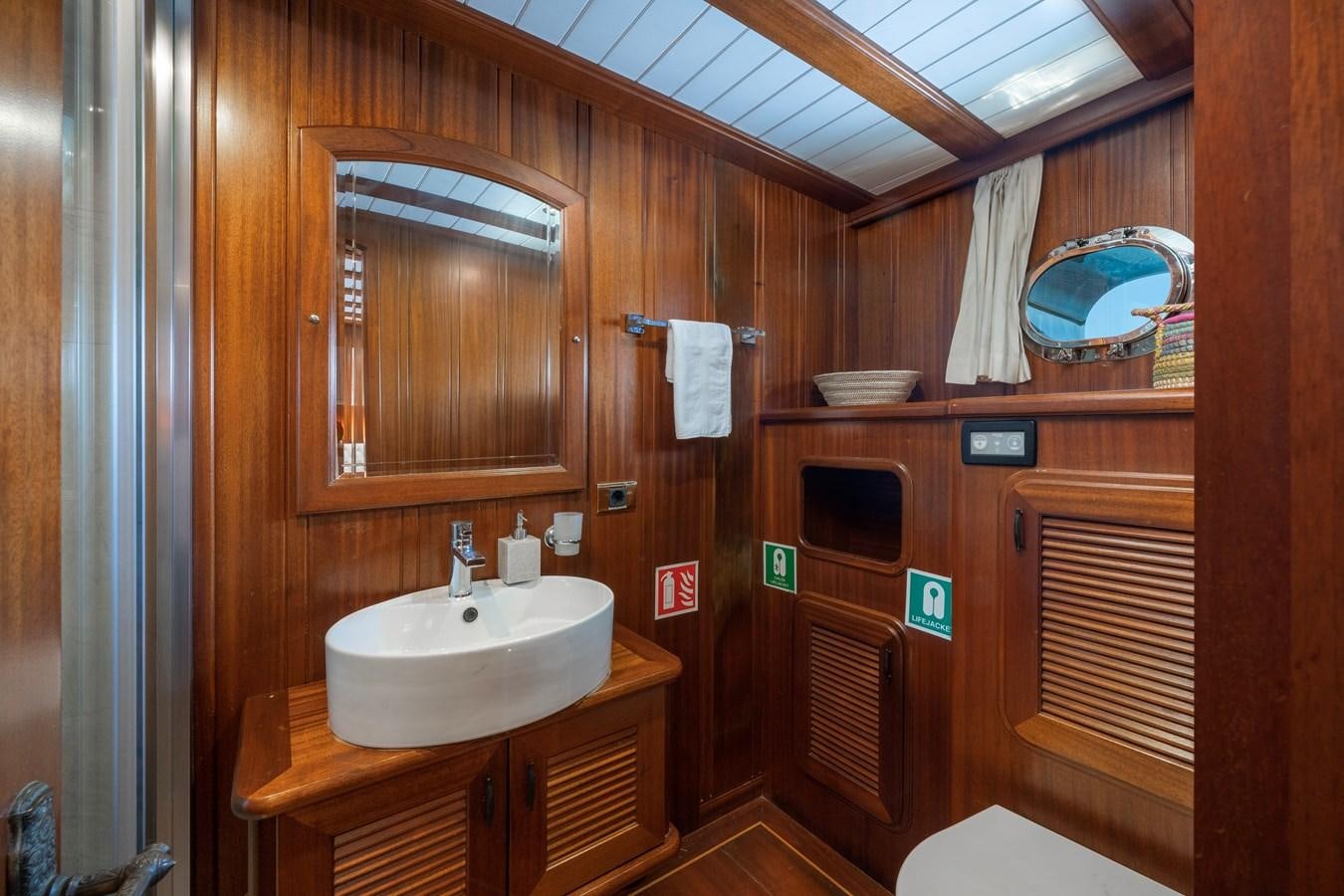 a bathroom with a sink and a mirror aboard L'ORIENT Yacht for Sale