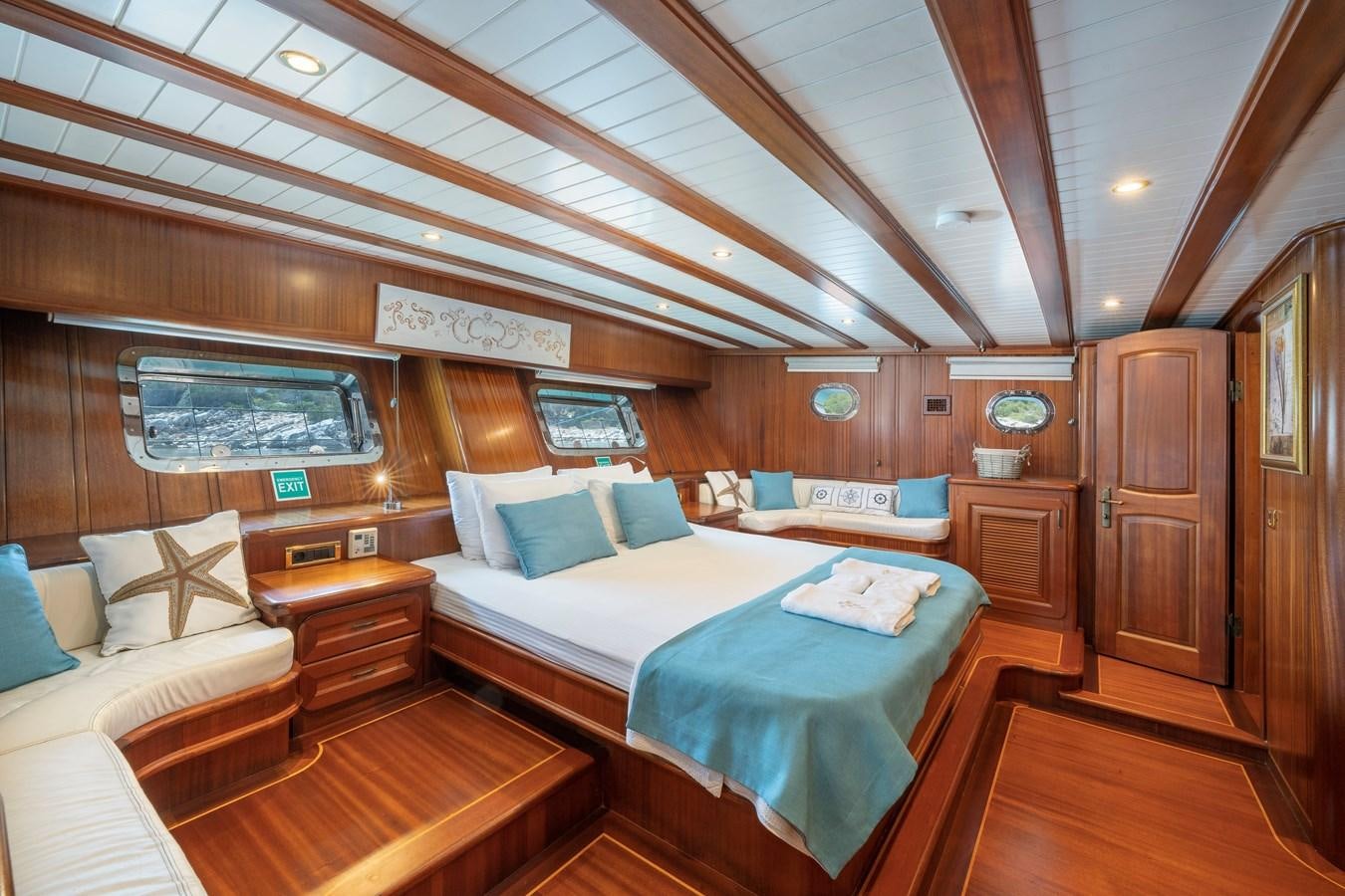 a cabin with a bed and a couch aboard L'ORIENT Yacht for Sale