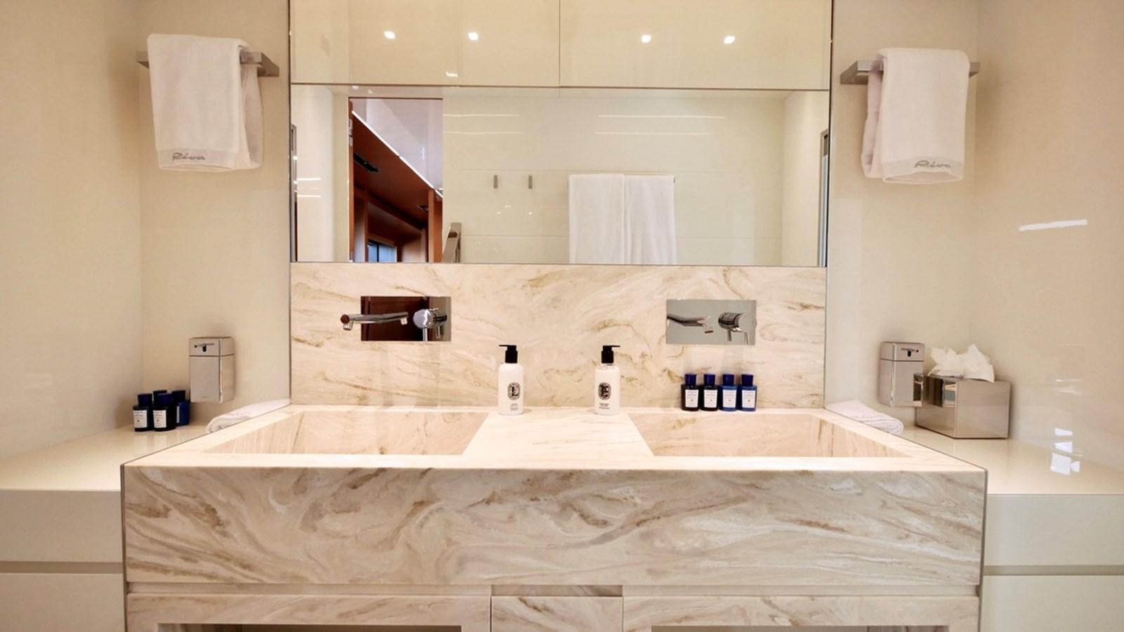 a bathroom with a large mirror aboard BASILIC Yacht for Sale