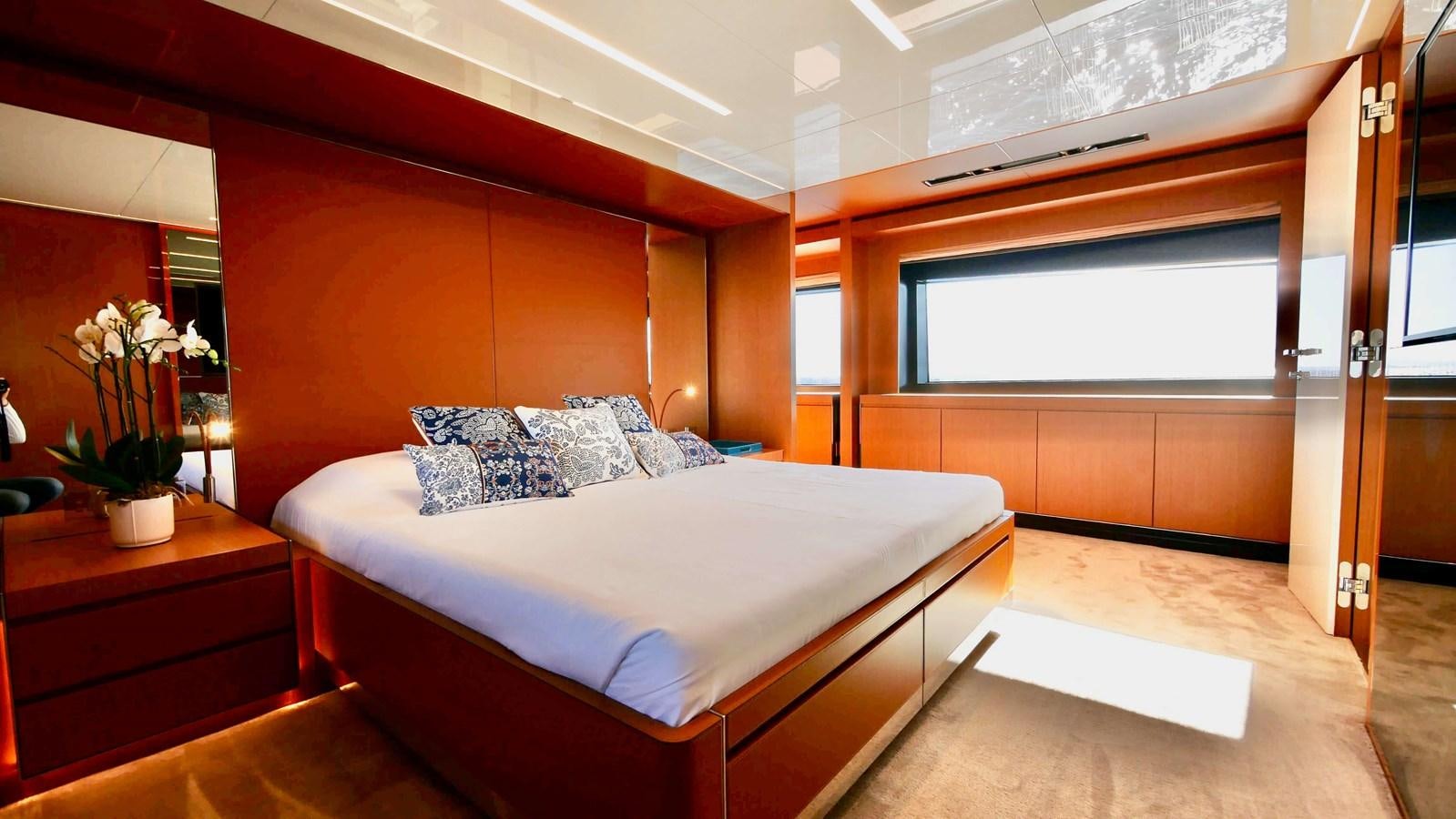 a bedroom with a bed and a desk aboard BASILIC Yacht for Sale