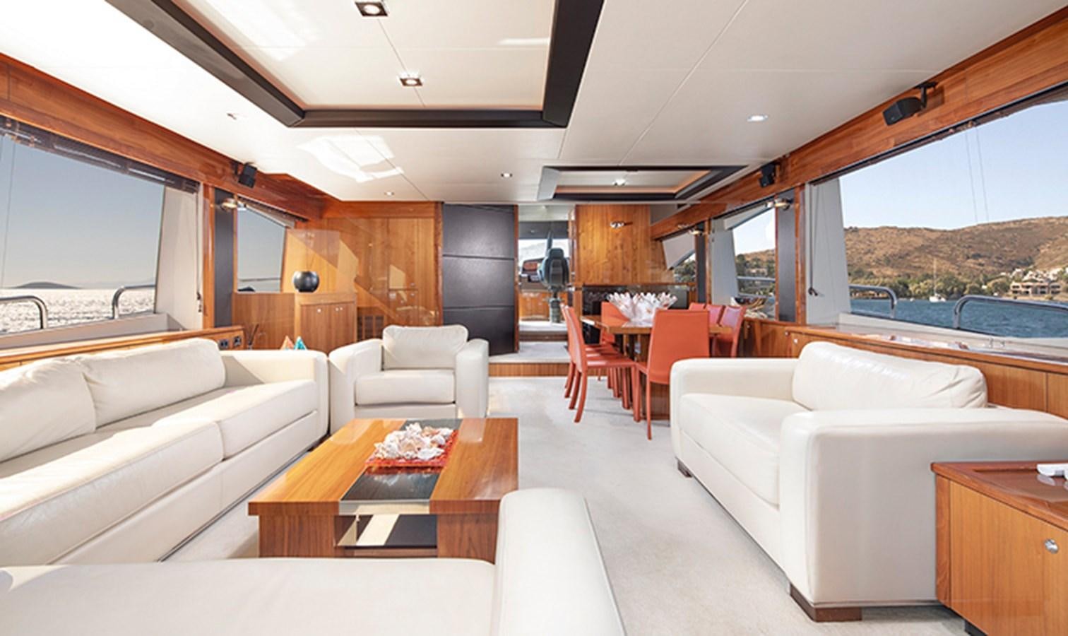 a living room with a couch and a table aboard SSM Yacht for Sale