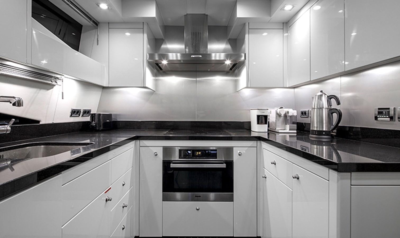 a kitchen with white cabinets aboard SSM Yacht for Sale