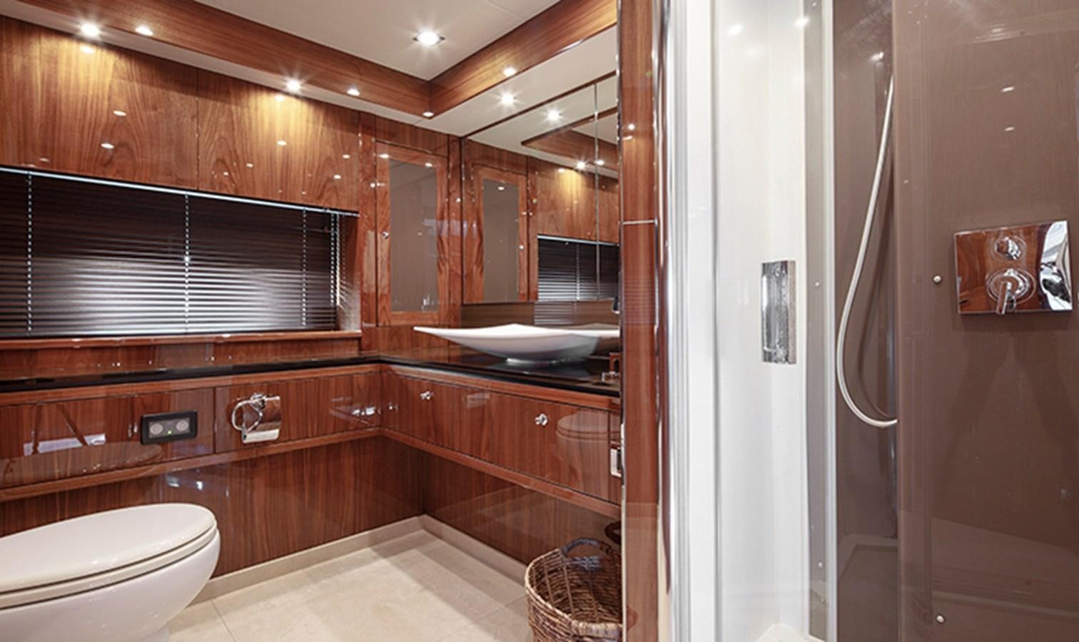 a bathroom with wooden cabinets aboard SSM Yacht for Sale