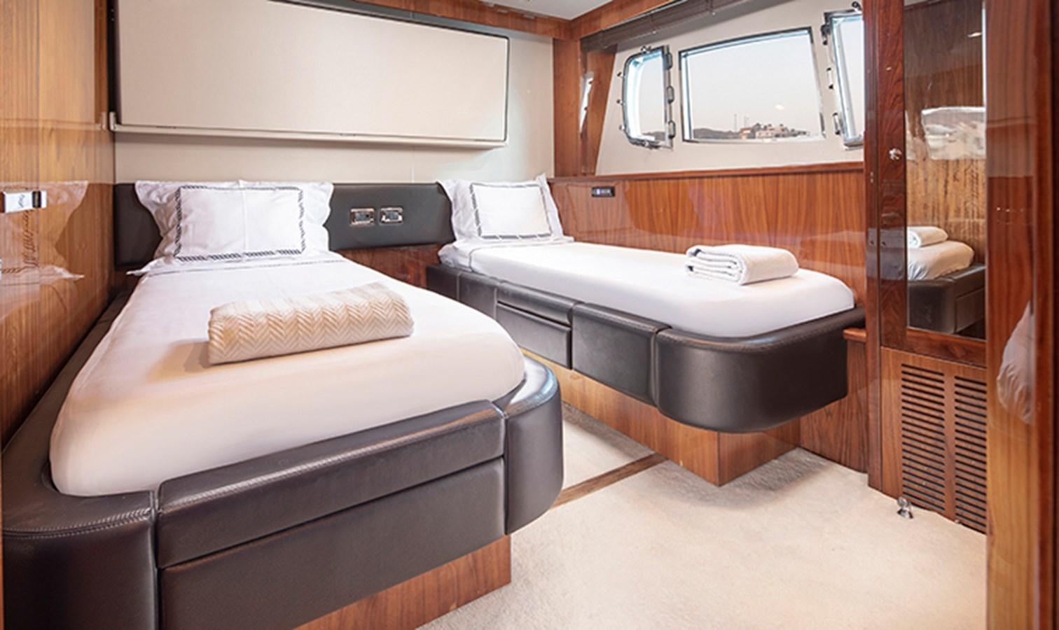 a room with a bed and a mirror aboard SSM Yacht for Sale