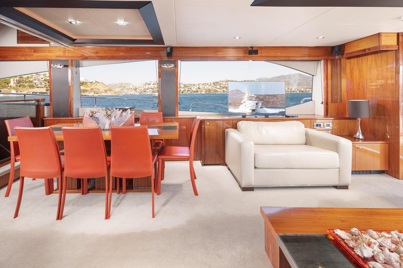 a room with a couch and a table and chairs aboard SSM Yacht for Sale