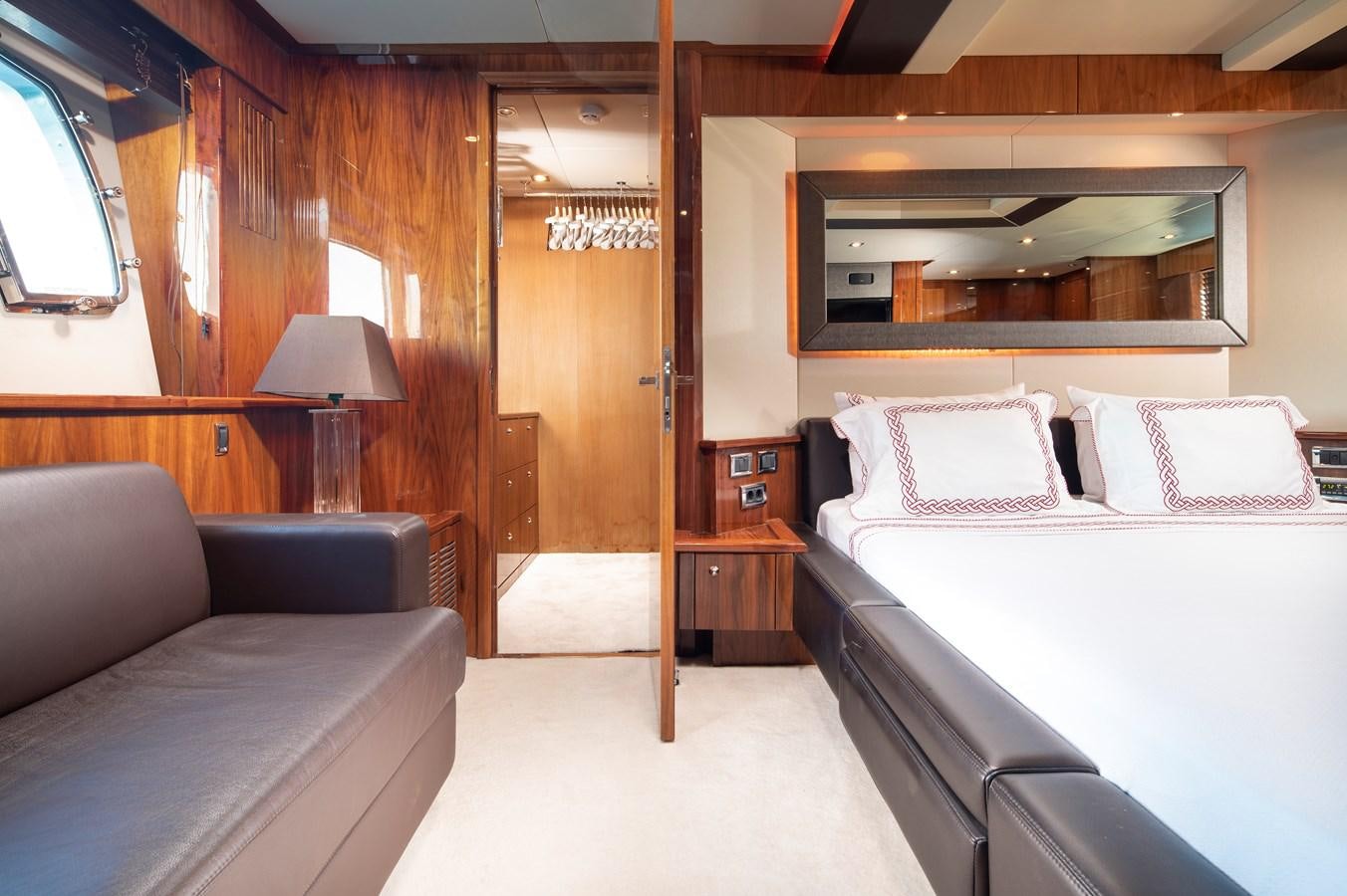 a room with a bed and a mirror aboard SSM Yacht for Sale