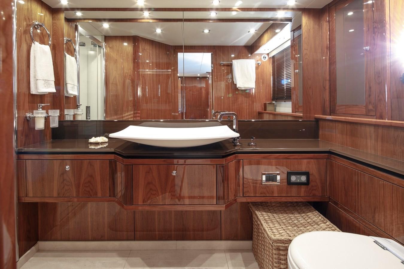 a bathroom with a large mirror aboard SSM Yacht for Sale