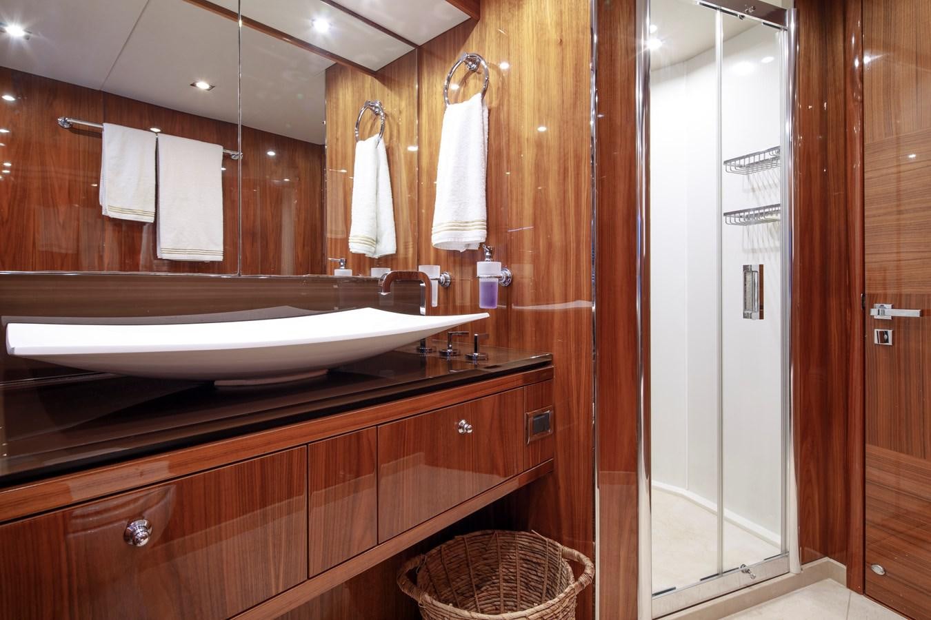 a bathroom with a large mirror aboard SSM Yacht for Sale