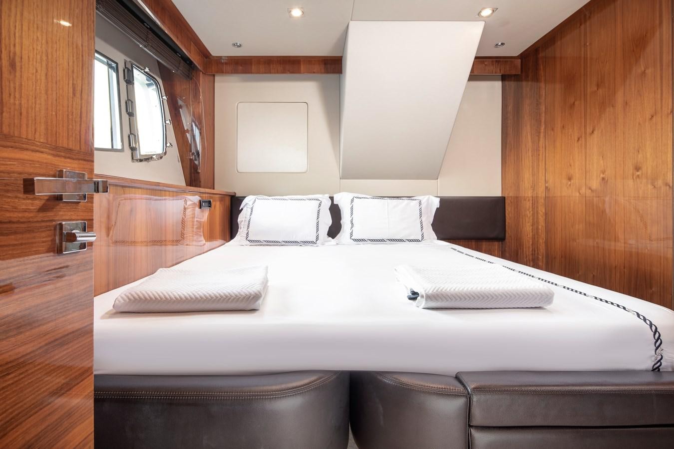 a bed with white sheets aboard SSM Yacht for Sale