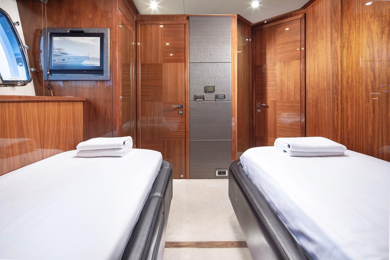 a room with a bed and a television aboard SSM Yacht for Sale