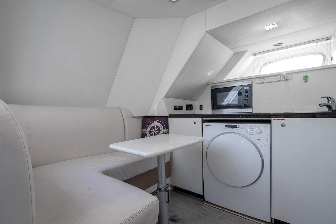 a room with a bed and a table aboard SSM Yacht for Sale