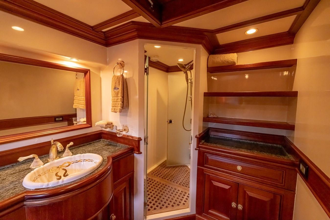 a bathroom with a sink and a mirror aboard 85 CLASSIC Yacht for Sale