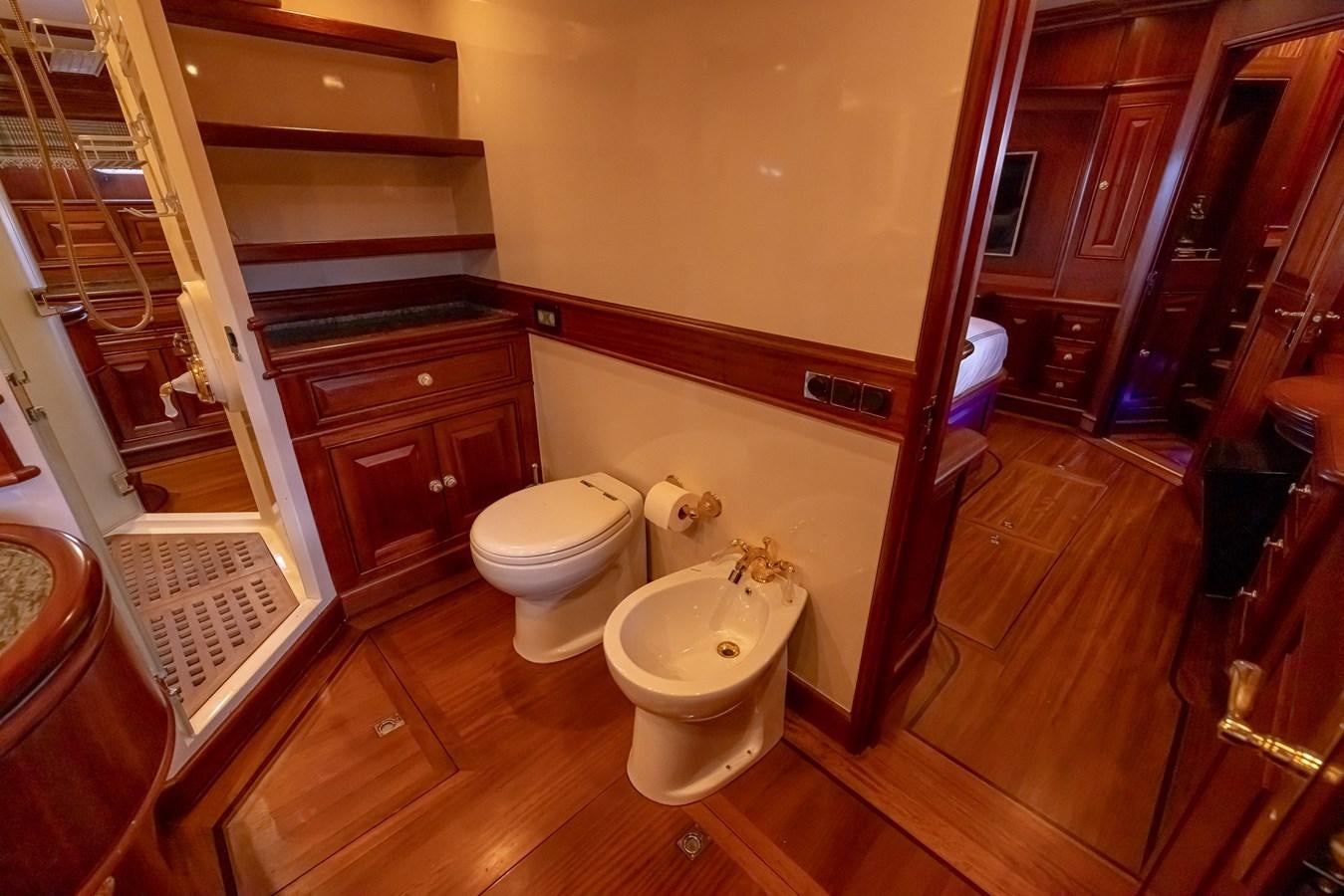 a bathroom with a toilet and a sink aboard 85 CLASSIC Yacht for Sale
