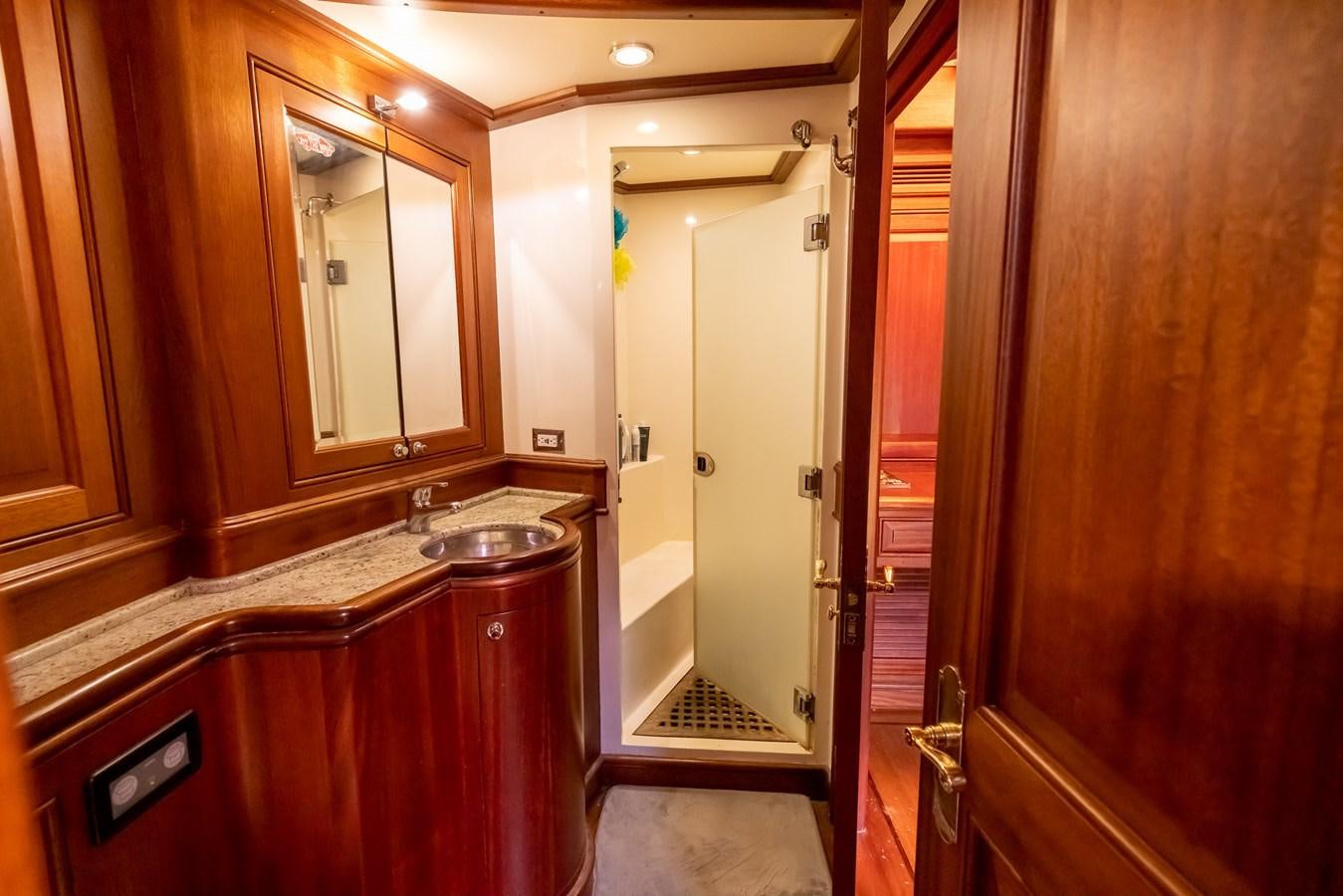 a bathroom with a sink and a mirror aboard 85 CLASSIC Yacht for Sale