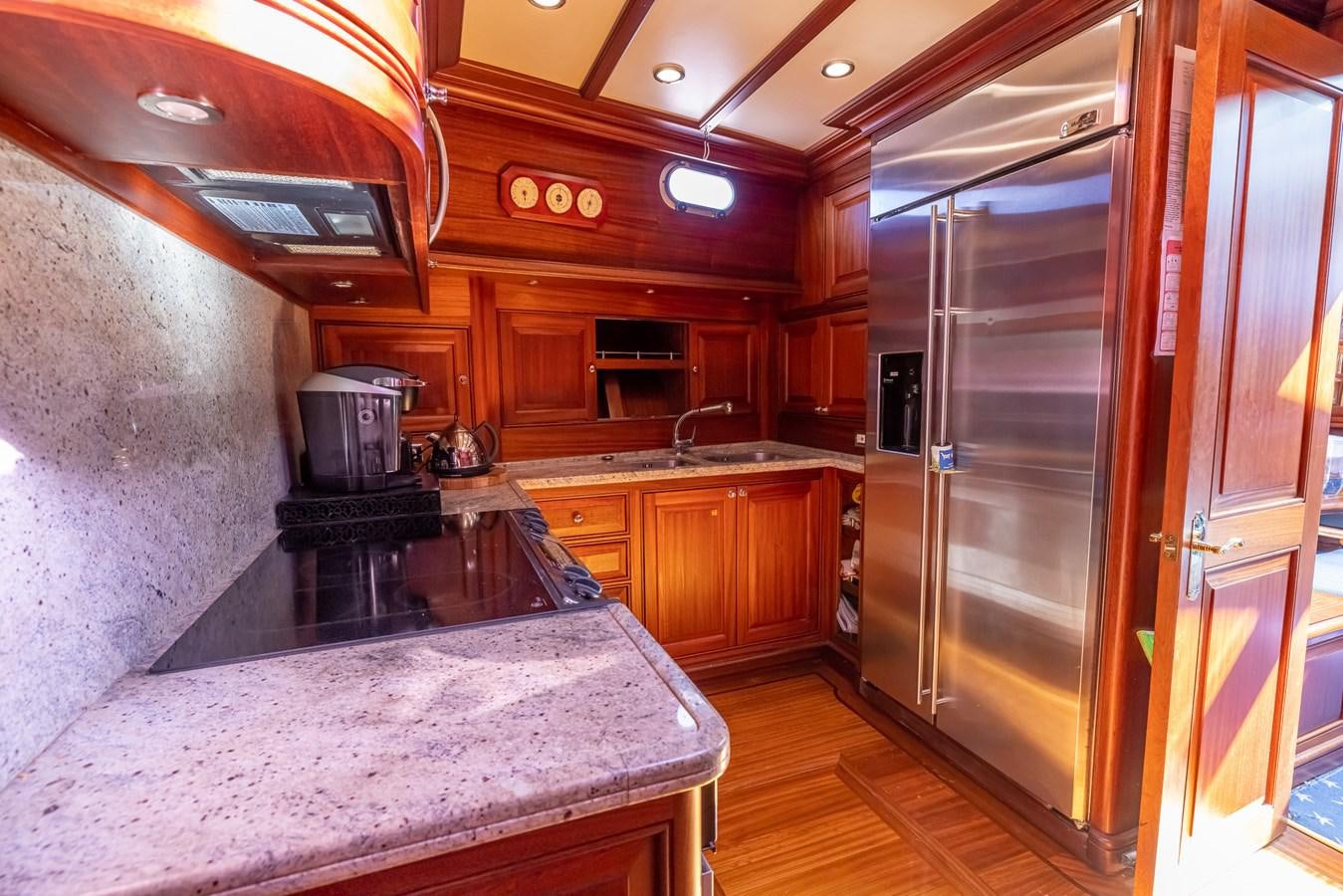 a kitchen with a large stainless steel refrigerator aboard 85 CLASSIC Yacht for Sale