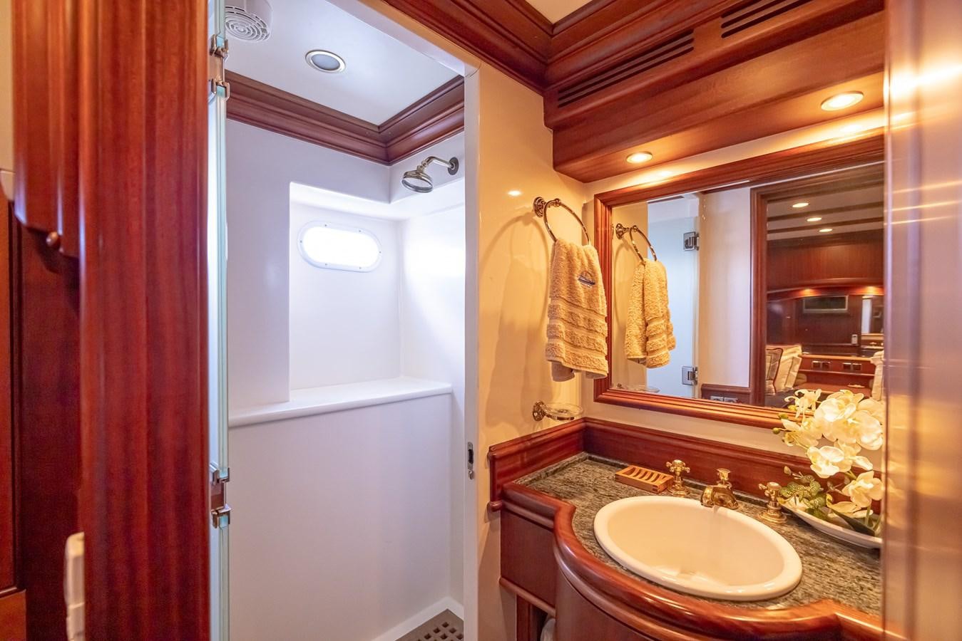 a bathroom with a sink and mirror aboard 85 CLASSIC Yacht for Sale