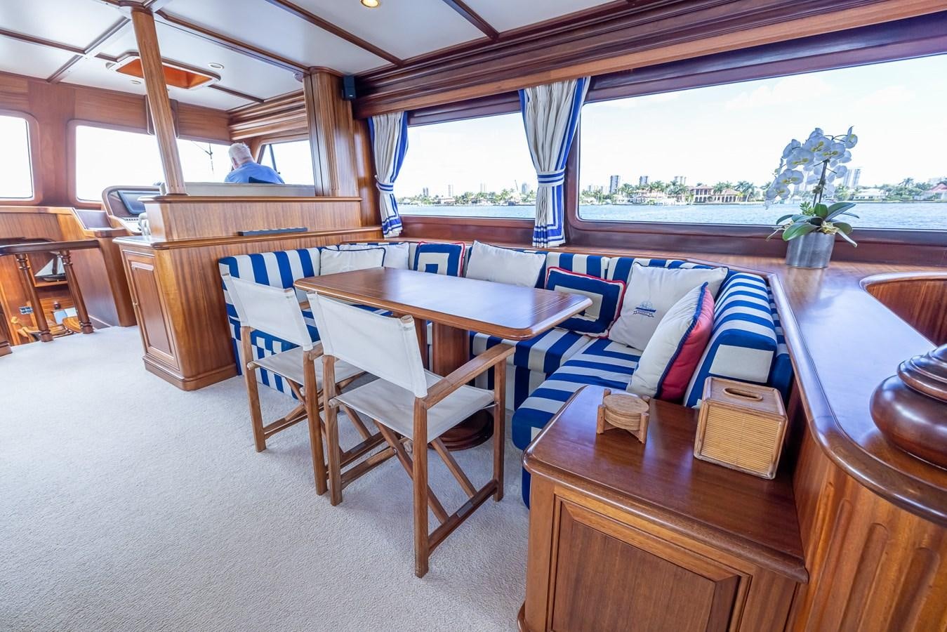 a room with a table and chairs aboard 85 CLASSIC Yacht for Sale